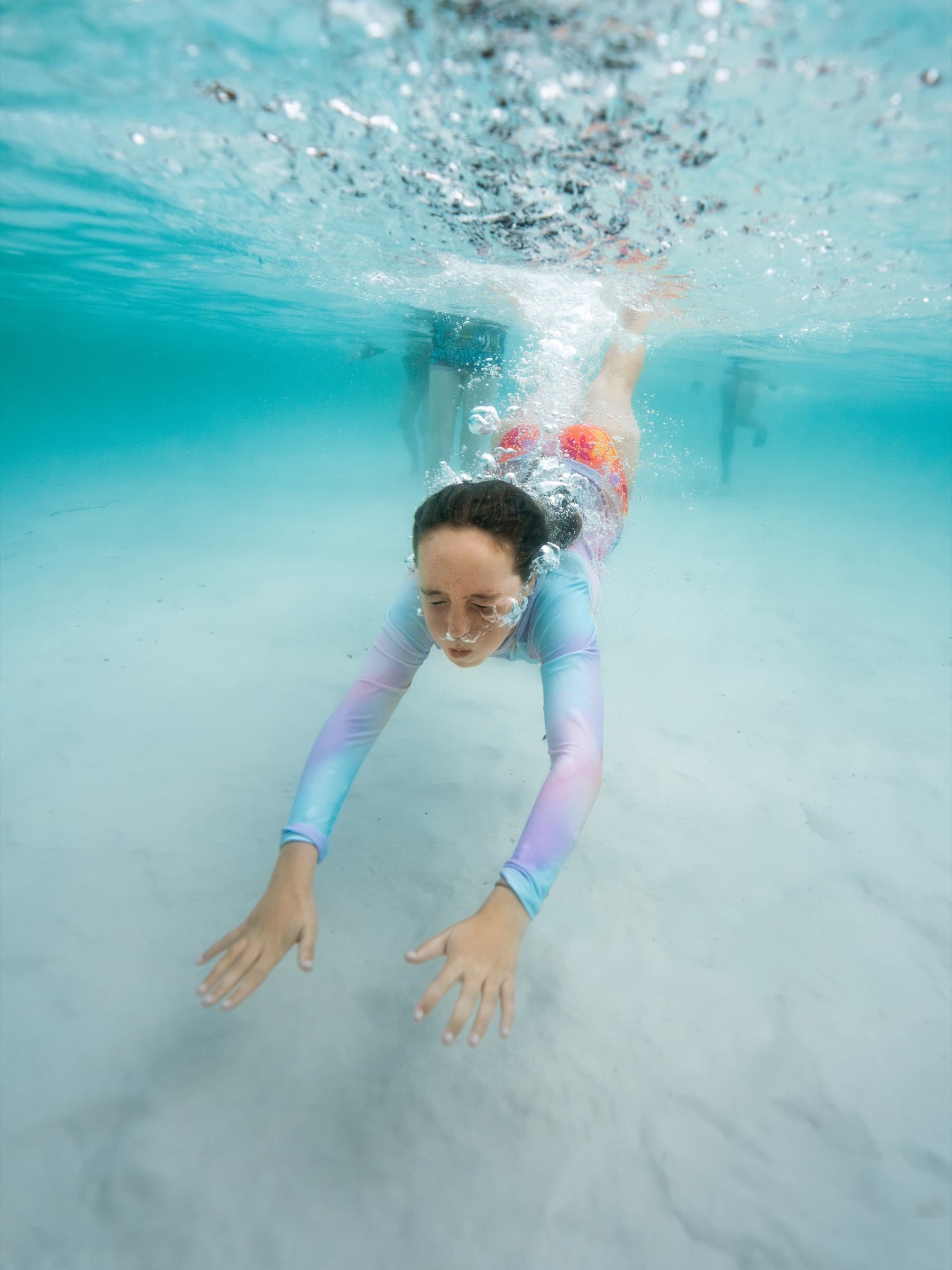 Girl swimming underwater in Lake McKenzie