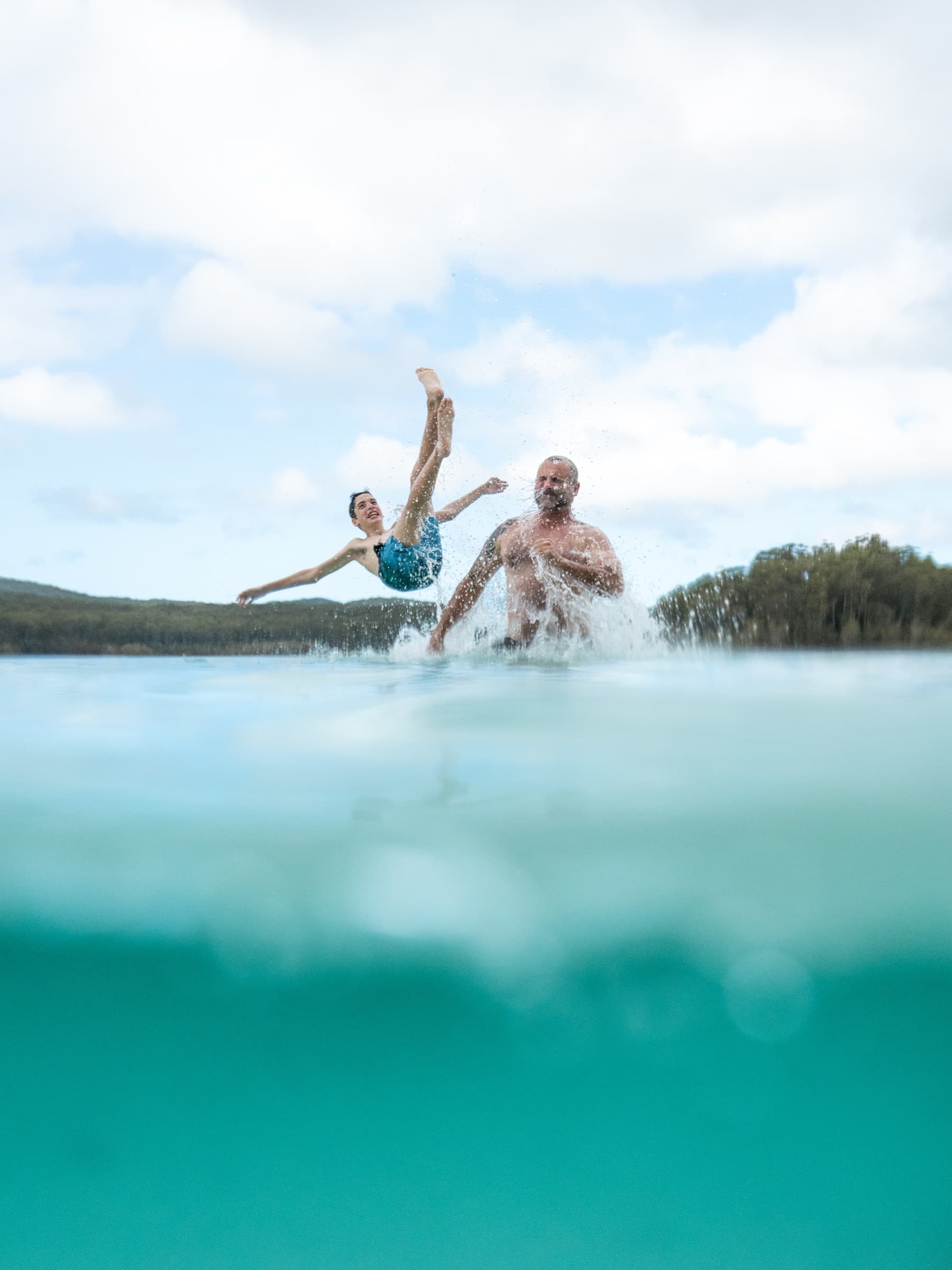 Dad throwing his kid into Lake McKenzie