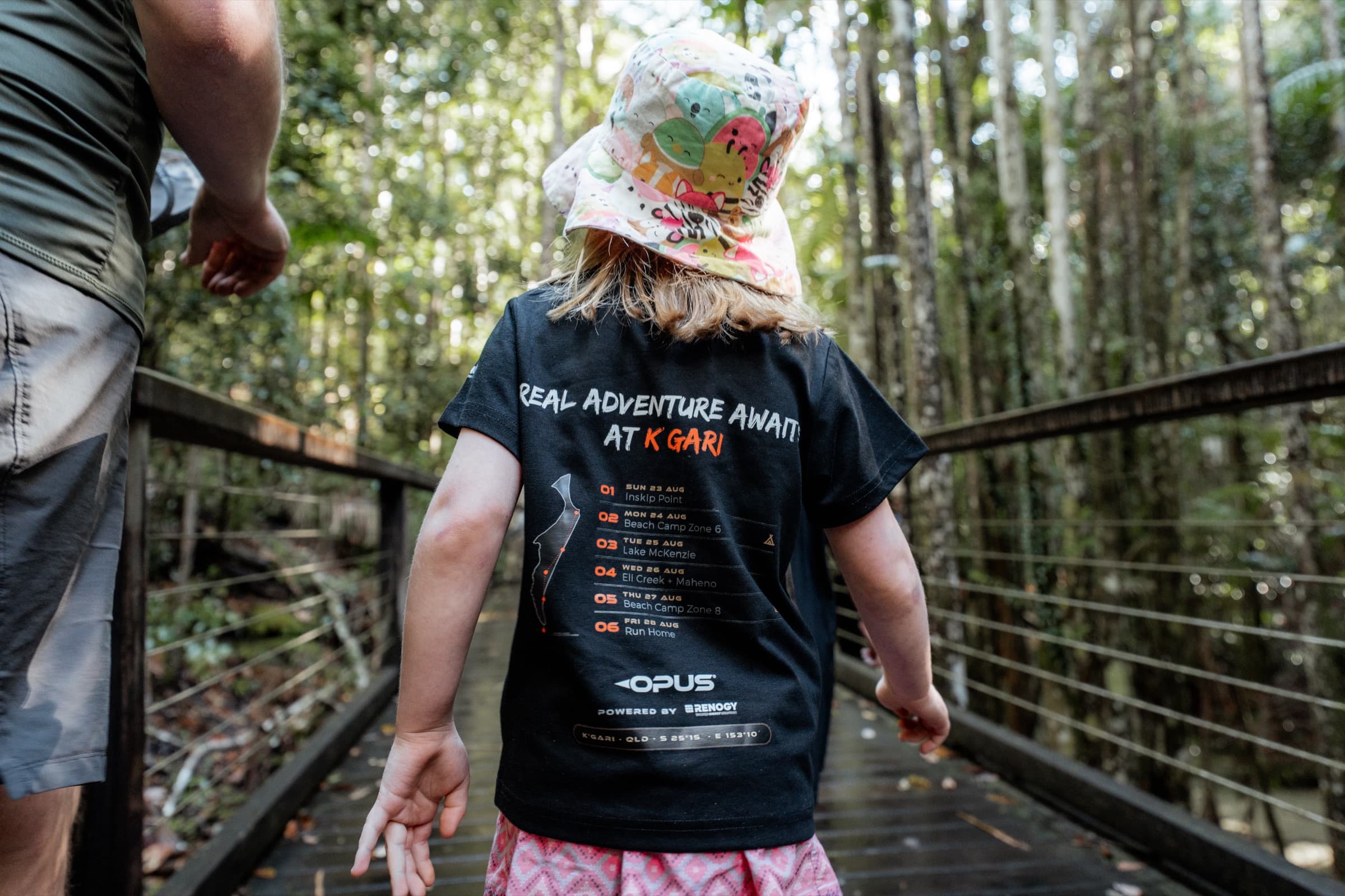 Kid in a Real Adventure Awaits at K'Gari tee walking a rainforest boardwalk