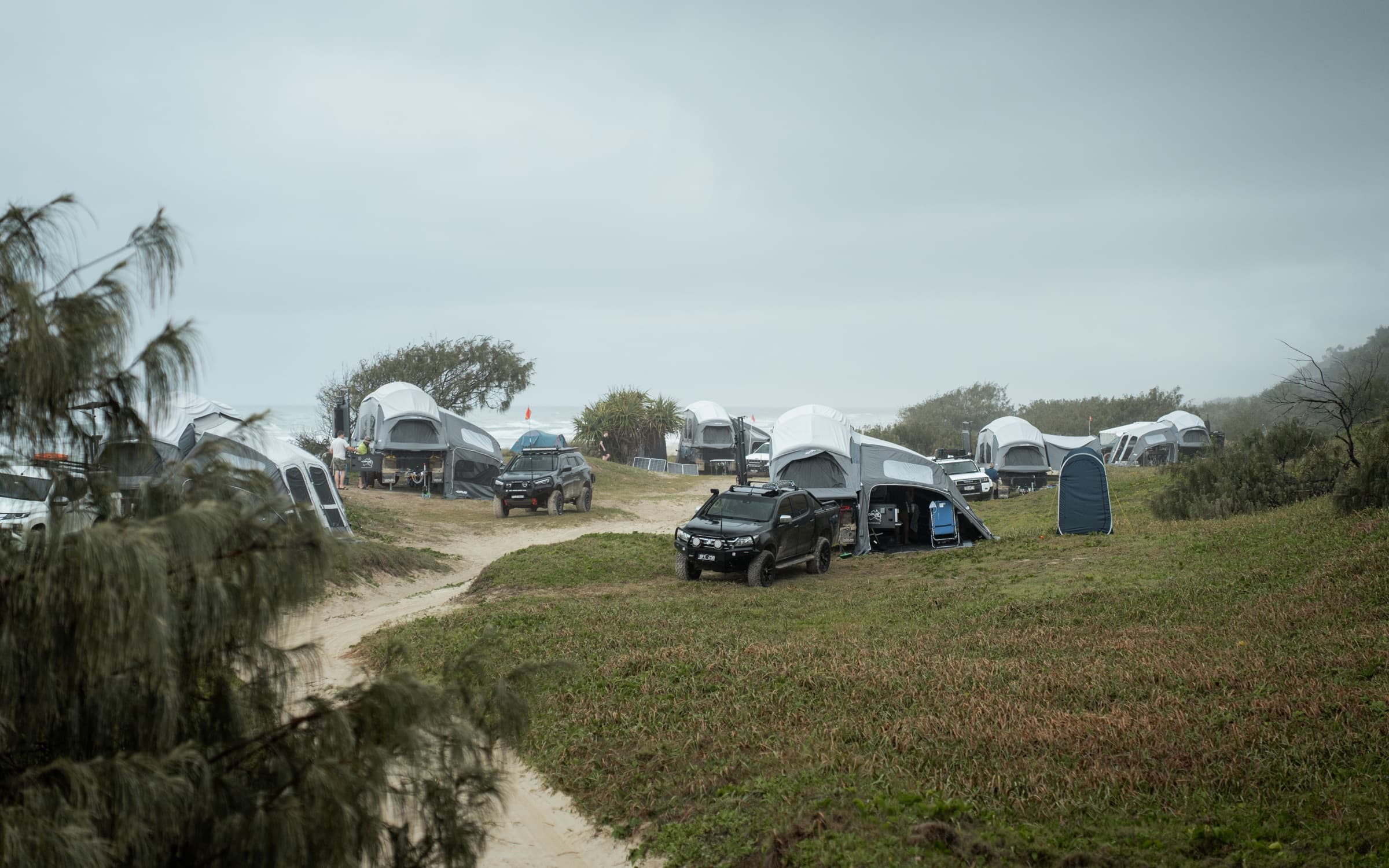 OPUS campers set up across a grassy campground