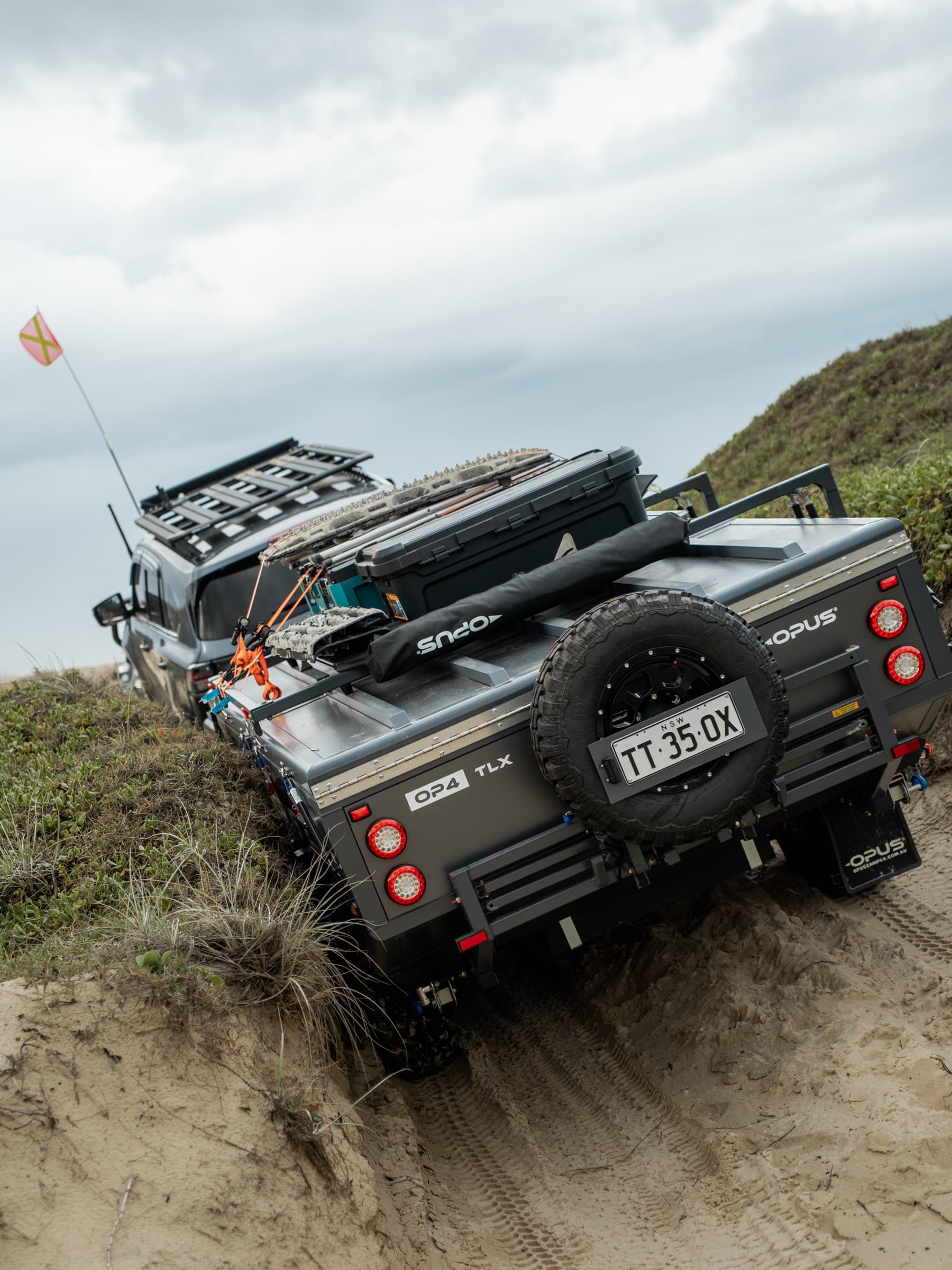 Rear of an OPUS hybrid on a steep sand track
