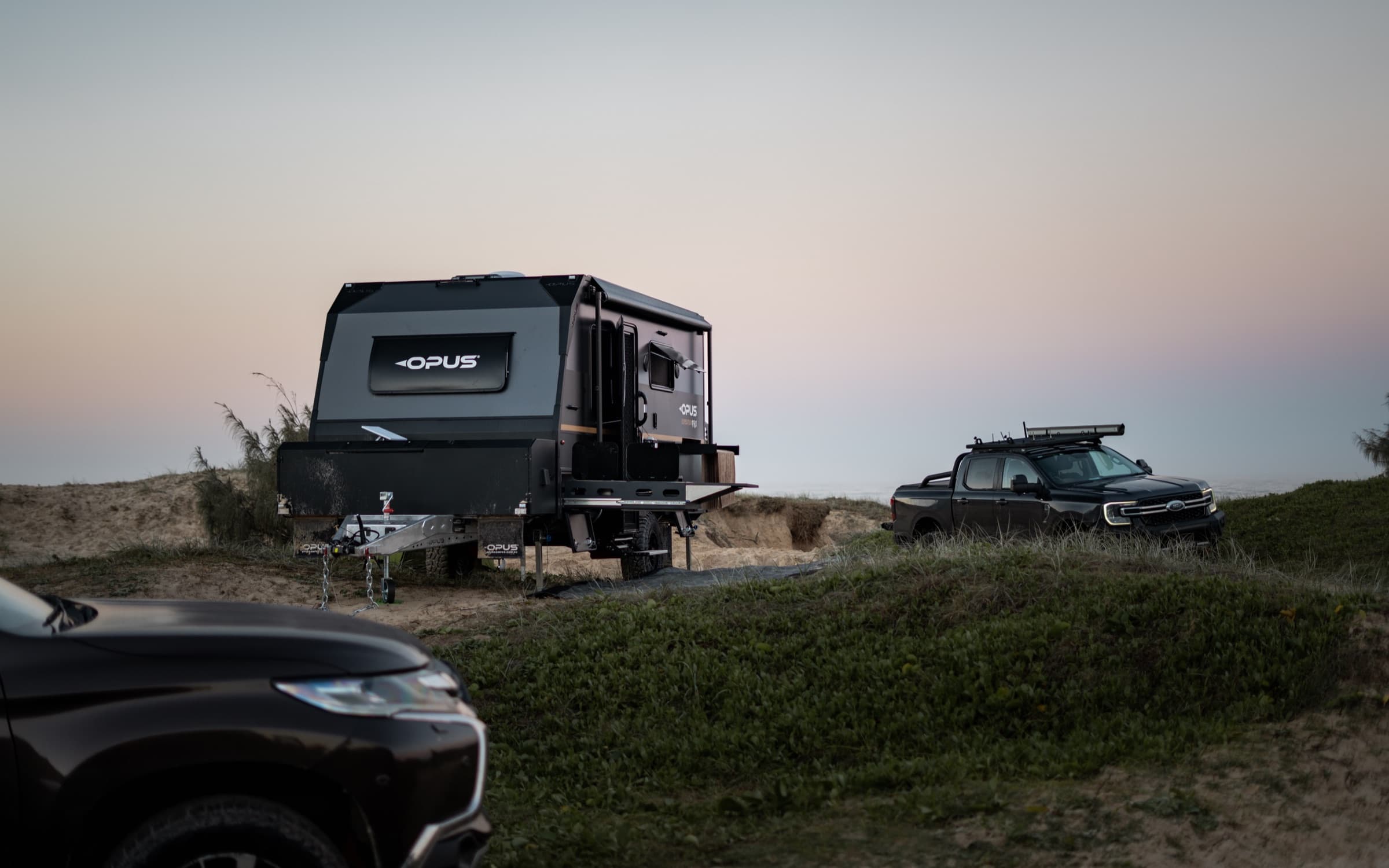 OPUS hybrid parked above the ocean at dusk