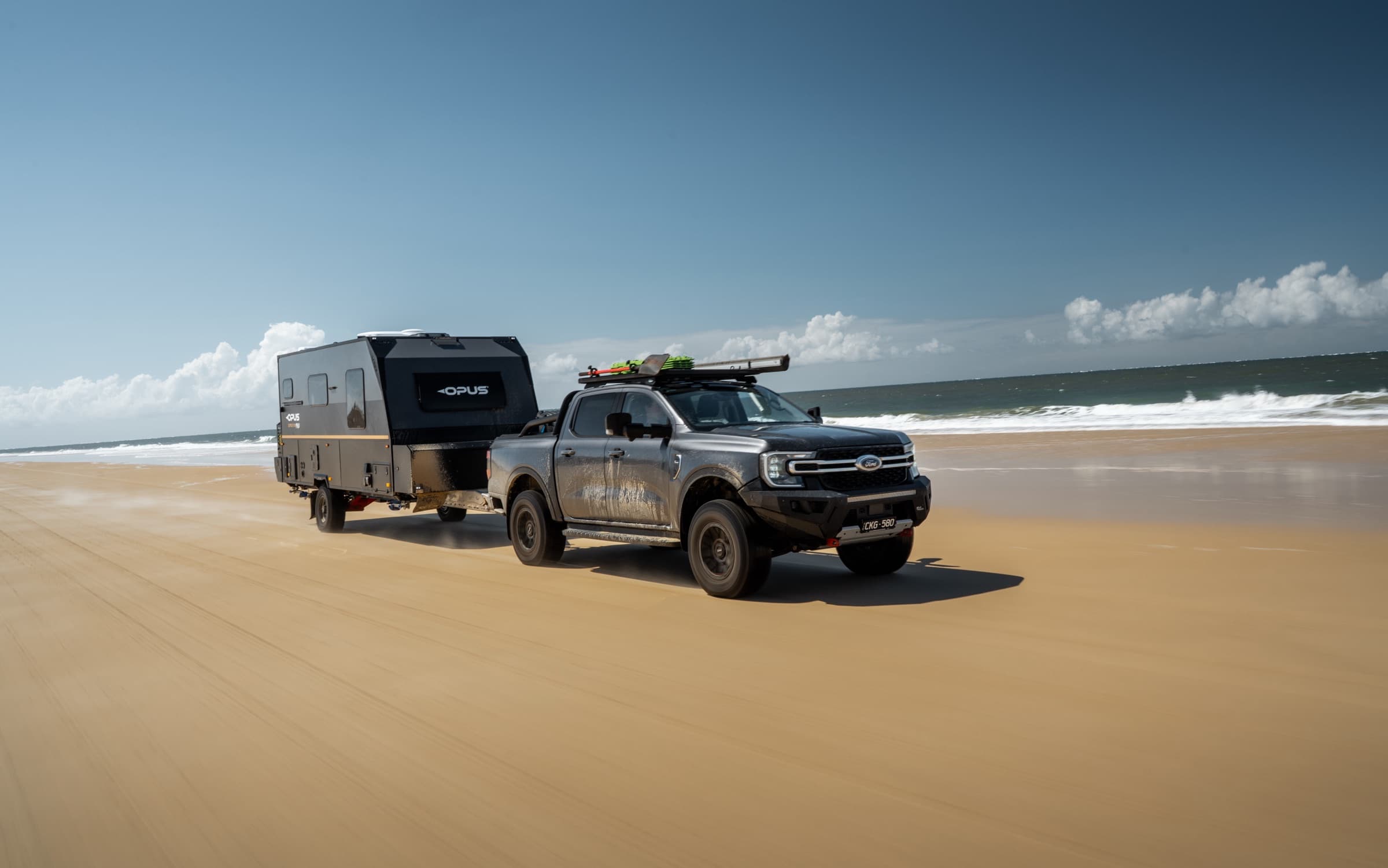 OPUS hybrid on the open beach under blue sky