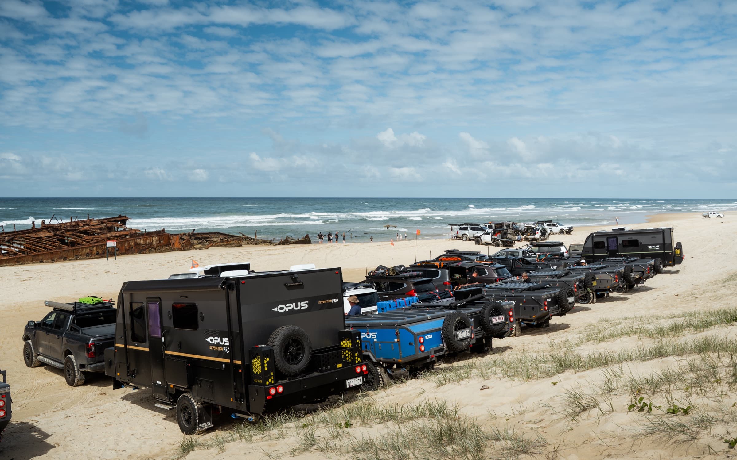 OPUS rigs parked in a row along the beach