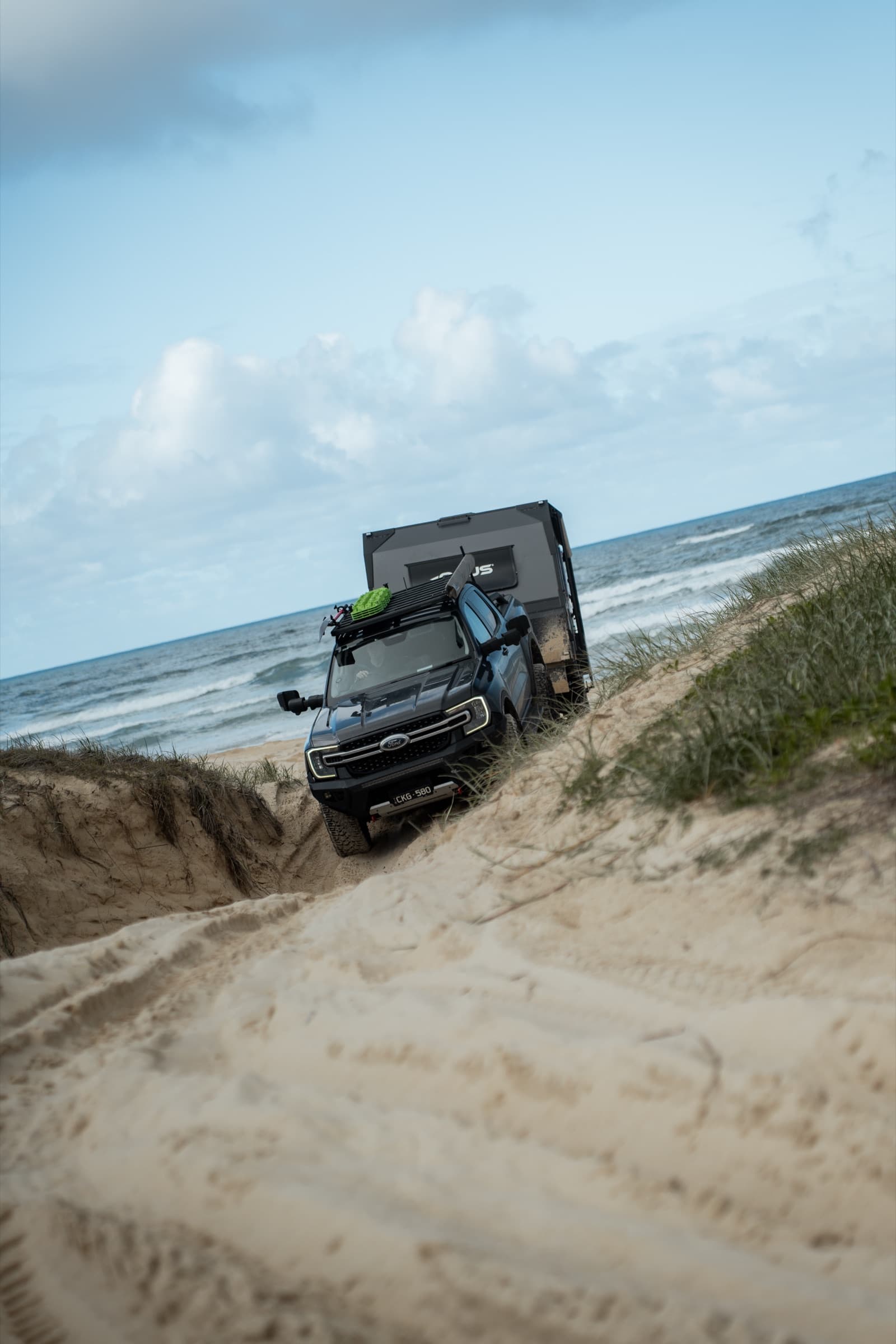 OPUS rig cresting a dune above the ocean