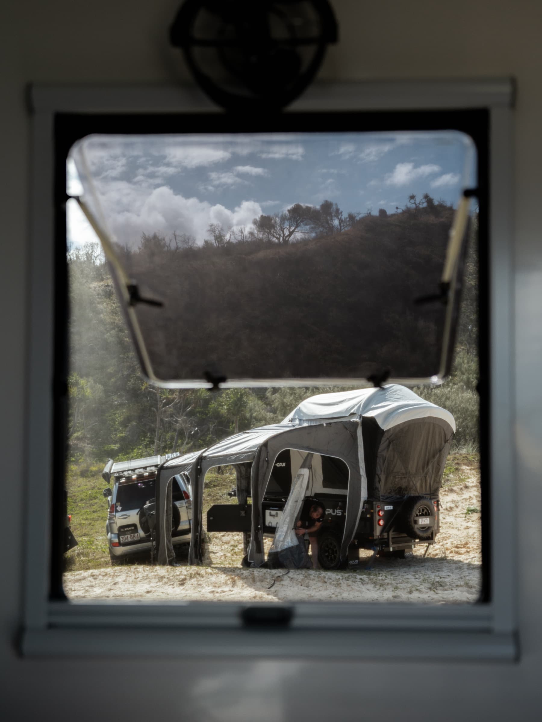 View of camp through an OPUS camper window
