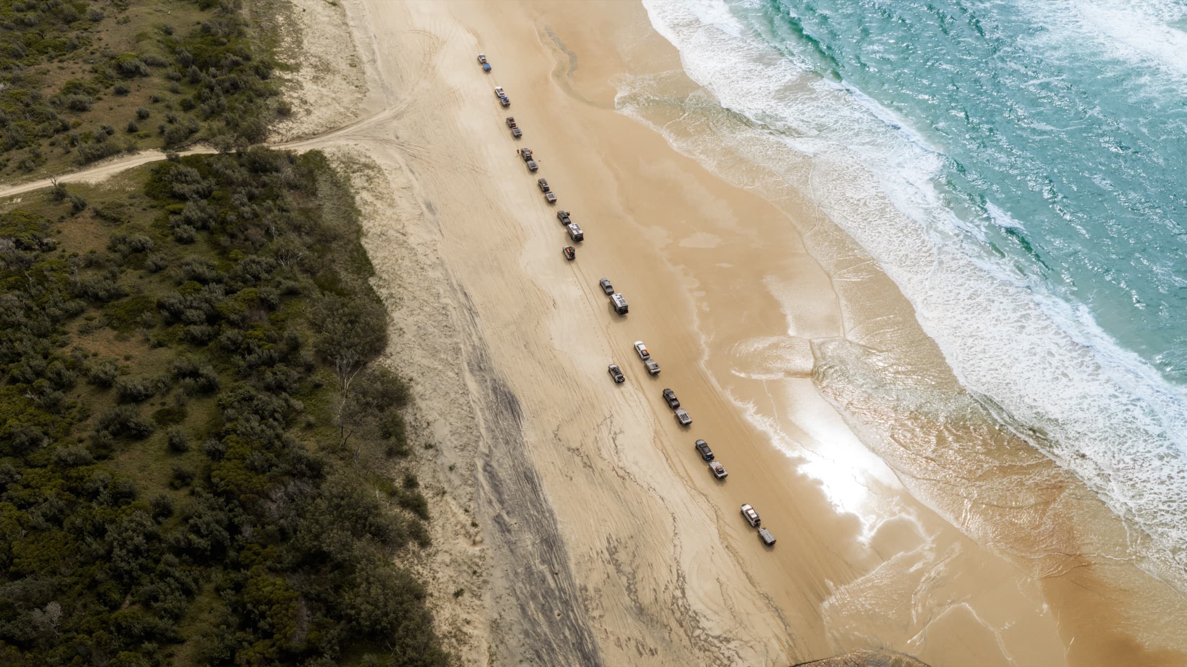 Aerial of the convoy strung out along the shoreline