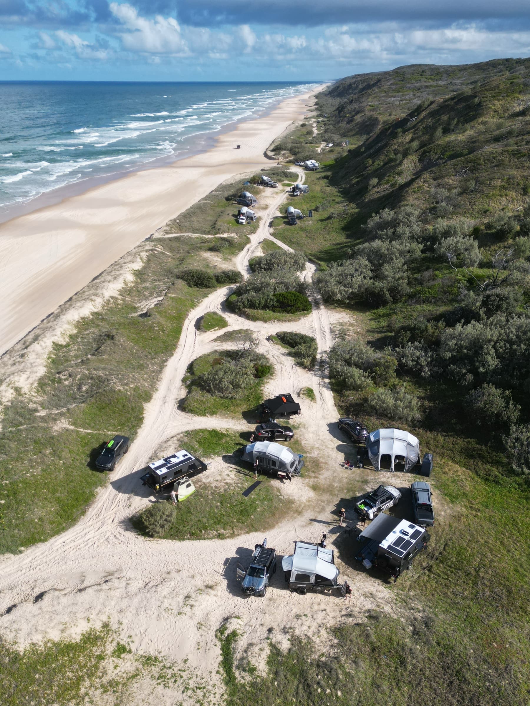 Adventure Run campers set up in the dunes above the surf