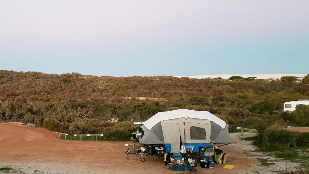 OPUS camper trailer on a remote Australian beach at sunset