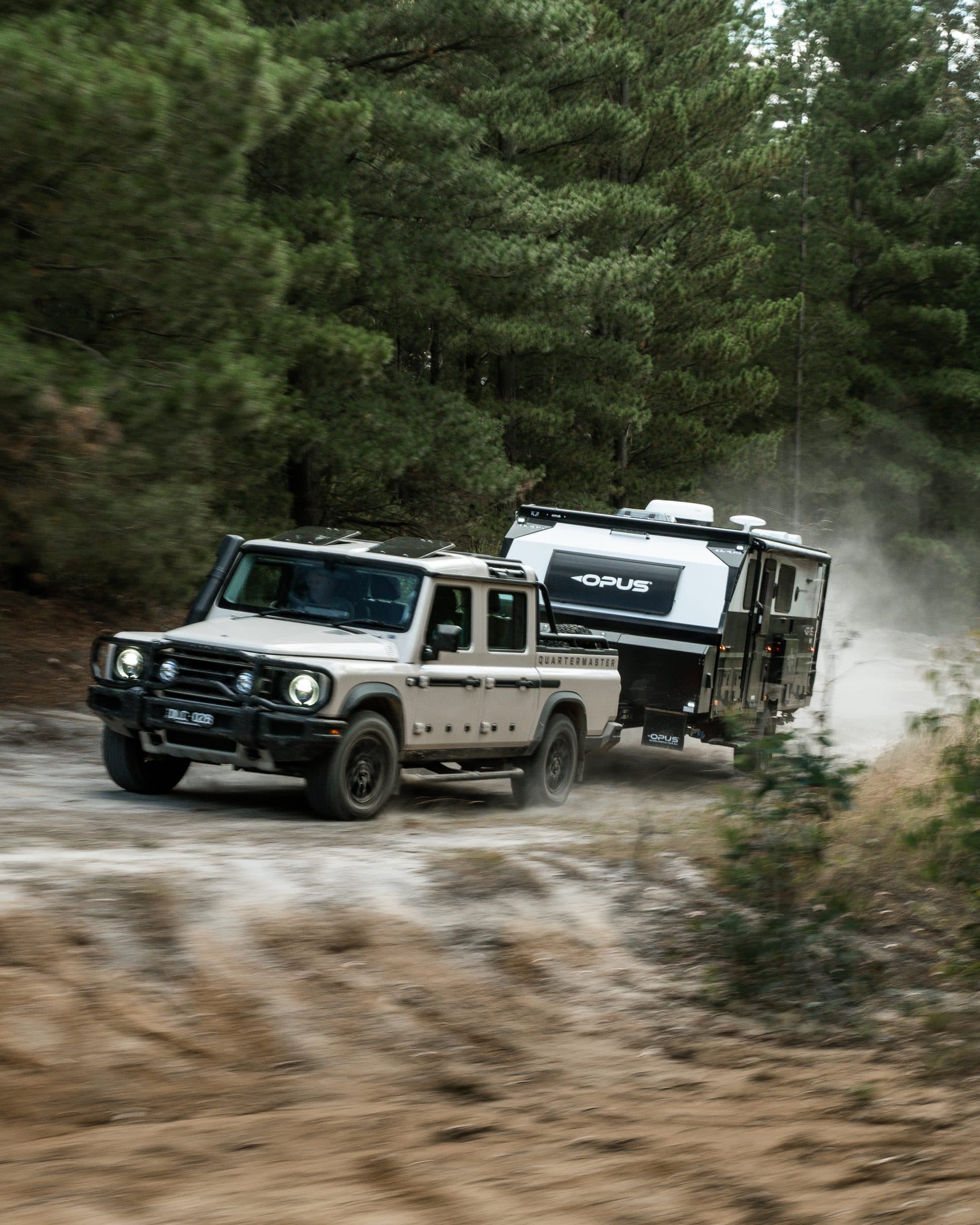 4WD towing an OPUS Expedition Max hybrid caravan along a dirt track